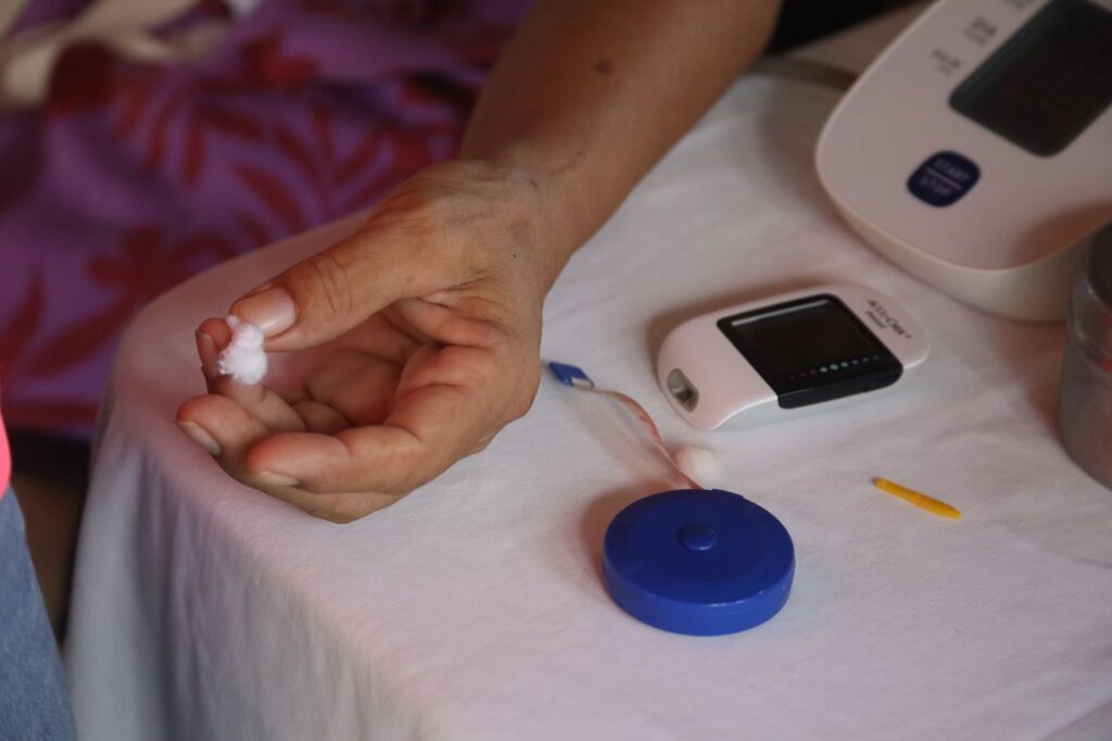 Mastering the First Impression: Your intriguing post title goes here Close-up of a hand using a glucometer for diabetes monitoring, highlighting health awareness.